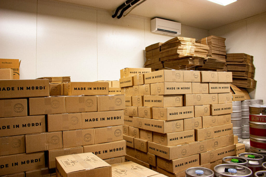 stack of cardboard boxes in a store room
